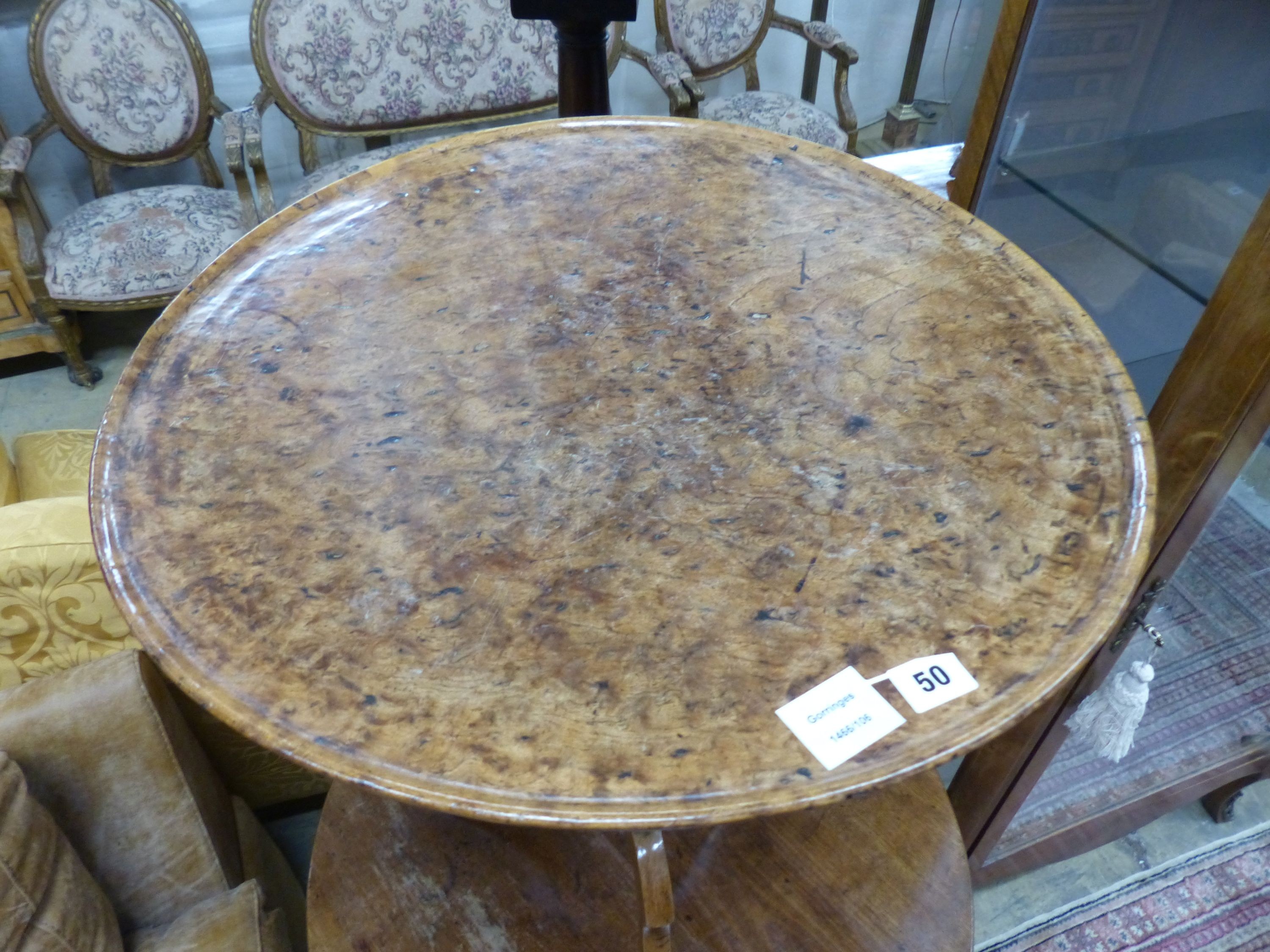 A George III oak and pollard oak circular tilt top tripod tea table (warped) Dia 57 H 67 cms.